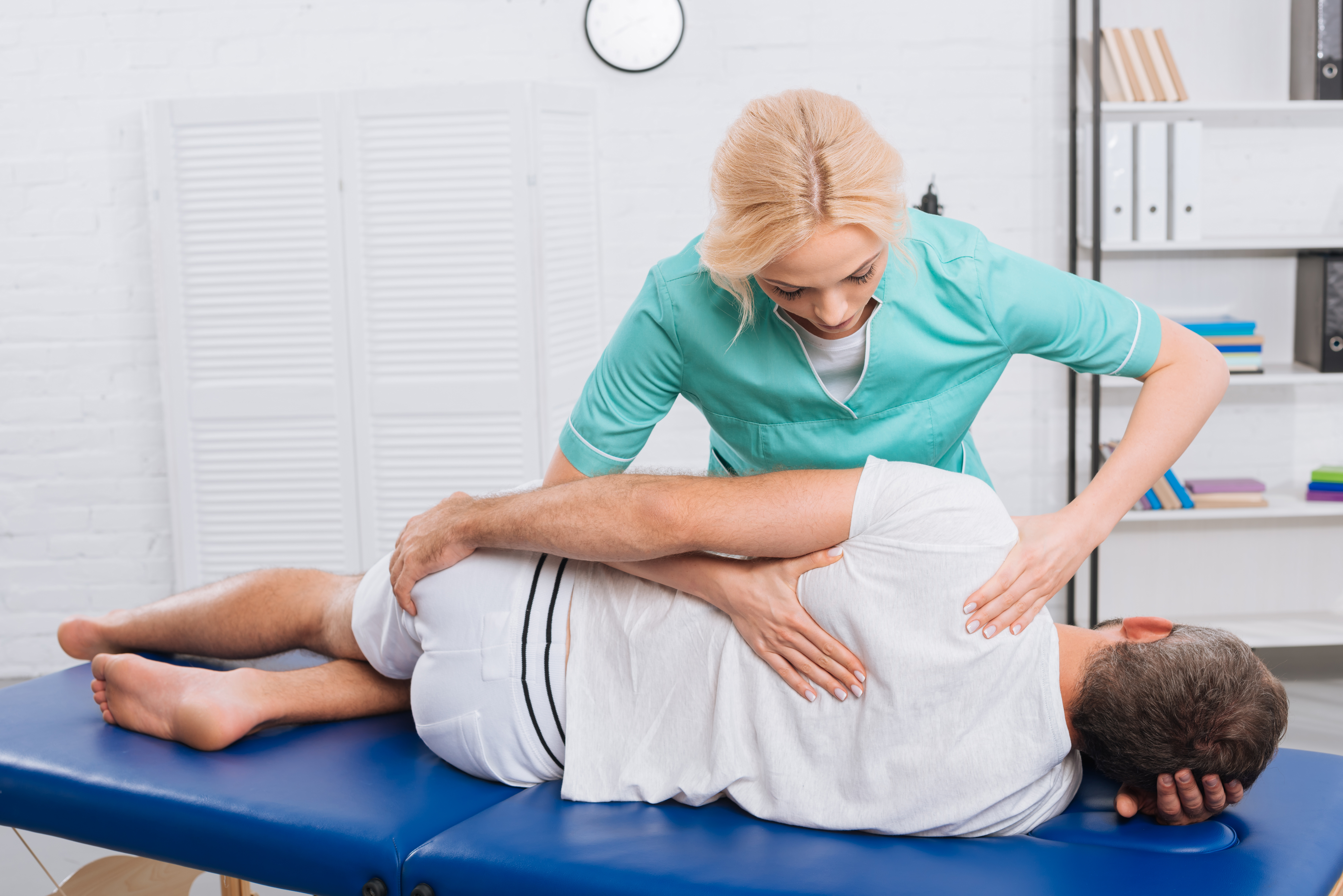 chiropractor massaging back on patient on massage 2022 12 16 20 04 55 utc