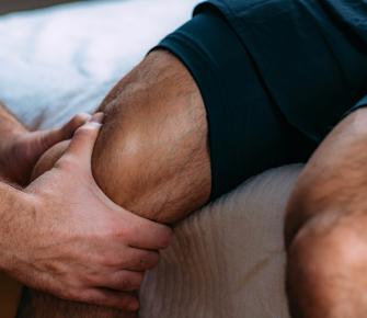 man-receiving-knee-massage-during-physical-therapy