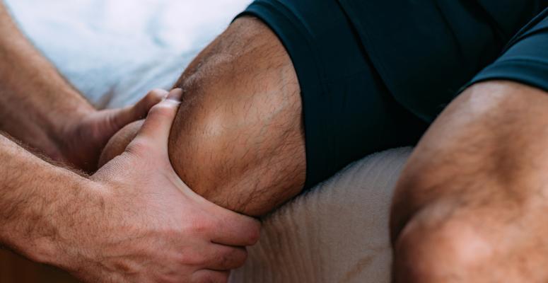 man-receiving-knee-massage-during-physical-therapy